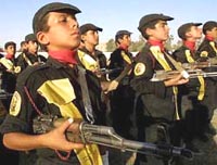 Photo of young military cadets, carrying rifles on parade